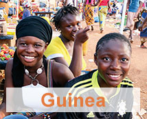 Three people celebrate in Guinea.