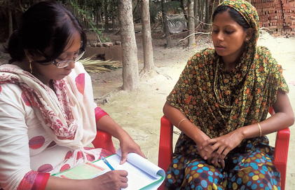 A woman talks with a health worker.