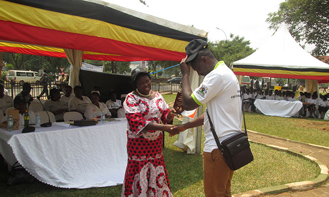 Hon. Dr. Moriku Joyce, the State Minister of Primary Health Care recognizes Moses Ssebale a SPRING representative during the national breastfeeding celebrations. SPRING played a critical role to organize the function.