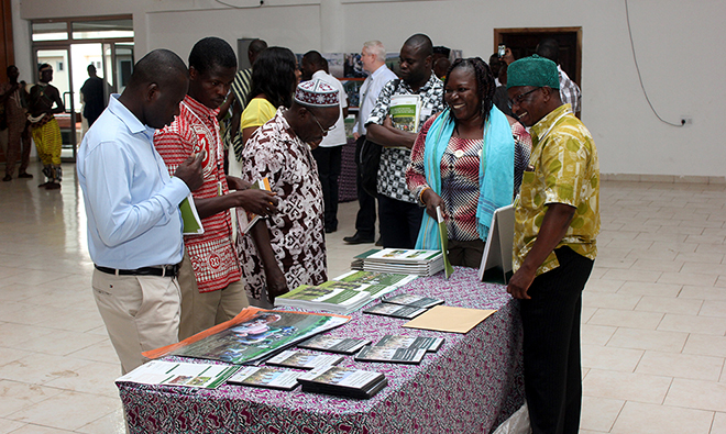 Picture of a group of people looking over a collection of nutrition informational materials on a table.