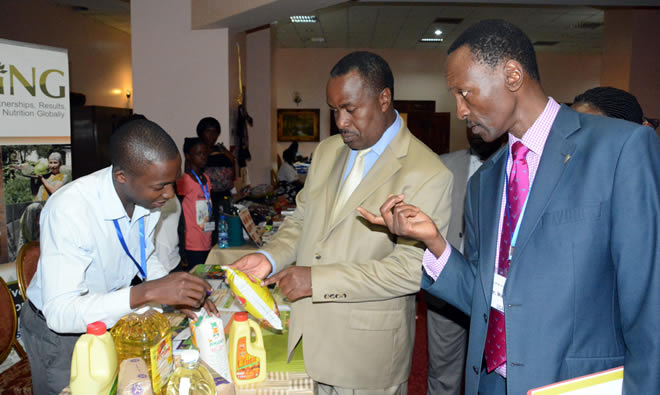 Minister of Health Dr. Elioda Tumwesigye visits the SPRING exhibit