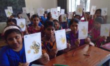 Children showing off their coloring for World Handwashing Day