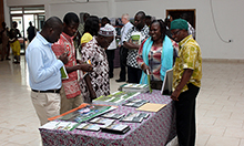 Picture of a group of people looking over a collection of nutrition informational materials on a table.