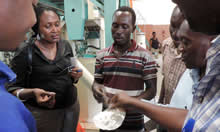 Talian Grain Millers' Production Manager holds up a scoop of fortified maize flour