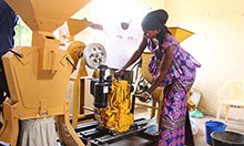 A trainee practices starting the motor of a cereal processor.