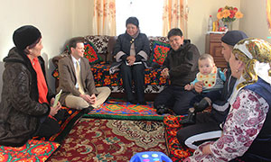 Nate Park, second from left, sits with Satybaldieva family, right, while SPRING volunteer Zuura Kydyralieva, left, talks to them about appropriate complementary feeding of their 11 month old son, Alinur. Mr. Park was joined by SPRING regional coordinator Dinara Boronbaeva, center, and USAID Osh representative Muhtar Irisov, center right.