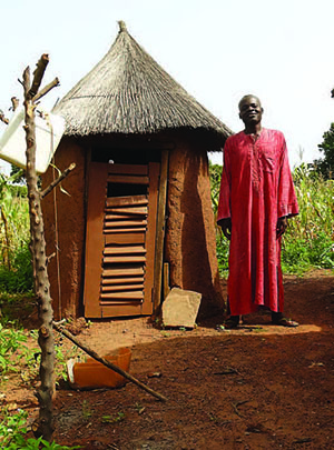  Abukari Imoro stands by his latrine, which has helped reduce the incidence of disease in his community.