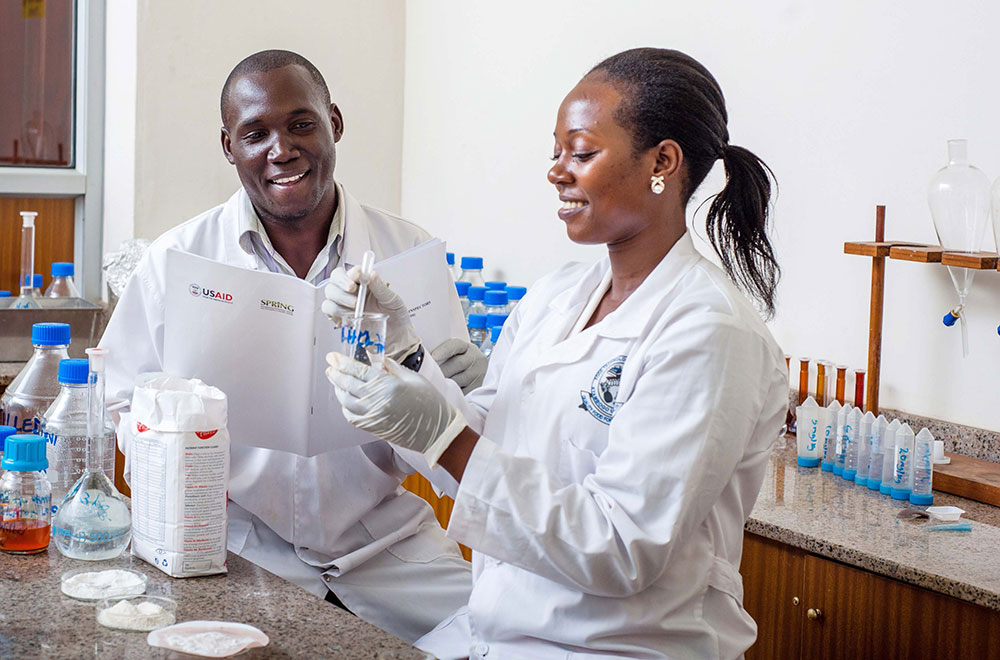 Thomas Okoth and Justine Nabuuma of Uganda Industrial Research Institute (UIRI) perform an iron spot test on maize flour, to determine if the flour is fortified.