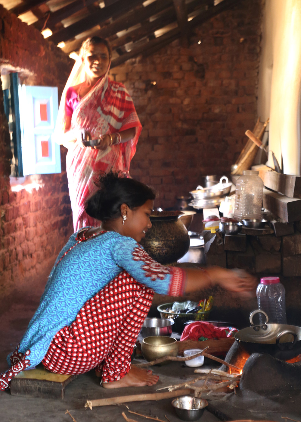 The mother’s sister prepares a midafternoon meal for the young child. Photo credit: Peggy Koniz-Booher