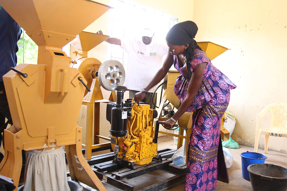 A trainee practices starting the motor of a cereal processor.