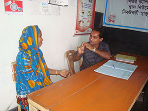 A health assistant meets with a patient at Atakathi Community Clinic.