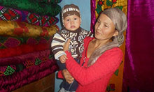 Seitova Raima holding her child