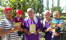 Photo of a group of women holding up SPRING nutrition counseling materials.