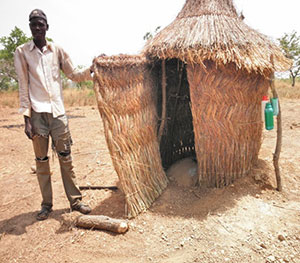 Gmangun Charles shows off his household’s newlatrine in the Kubone community in Ghana’s northern region.