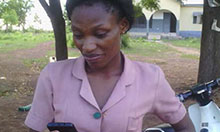 Faustina Kiisi, a community health nurse at Tolon Health Center, reaches out to her colleagues on WhatsApp.