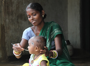 Women feeding her child complementary food