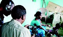 Cover image featuring a film crew making a community video. 