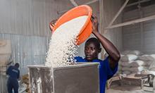 Photo of a man pouring flour into a machine