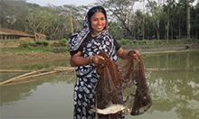 Women holds a net with a fish