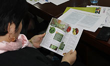 A participant looks at a copy of the new publication for home based storage and preservation of nutritious foods in the Kyrgyz Republic.