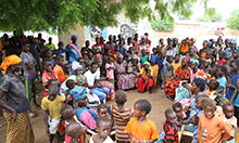 Dynaset-setal members speak during a village gathering to remind community members of key hygiene messages.
