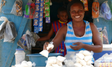 Photo of a woman selling food at a market stall