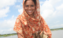 Photo of a woman smiling in front of a lake