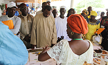 Photo: SPRING/Senegal nutrition advisor, Mariam Sy, speaks to guests about SPRING’s accomplishments in nutrition, gender and hygiene at one of the stands set up to showcase project achievements. 