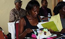 Photo: Goretti Kyebajia, a health facility staff from Namutumba district, reviews the MNP materials.