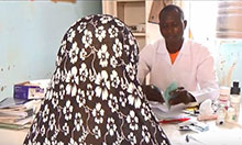 A woman speaks with a doctor at a health clinic